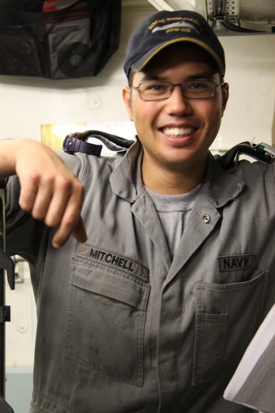 Smiling technician in work uniform, demonstrating friendly service approach, reflecting My Eride Guy's commitment to clear communication and quality repairs.